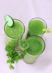 Three kinds of green juice on light background