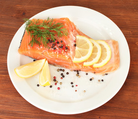 Fresh salmon fillet with herbals and lemon slices