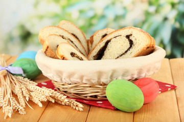 Loaf with poppy seed in wicker basket, on bright background