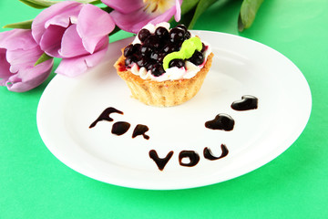 Sweet cake with blackberry and chocolate sauce