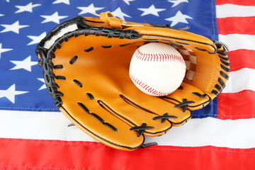 Baseball glove and ball on American flag background