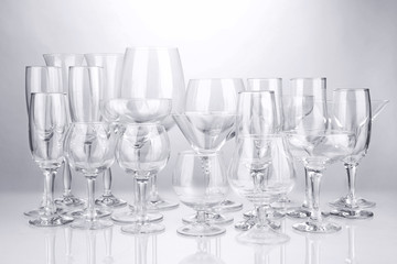 Cocktail and wine glasses, on gray background
