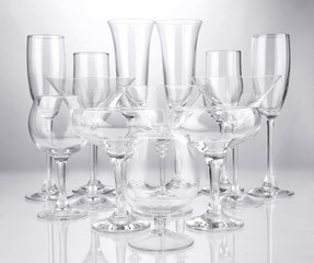 Cocktail and wine glasses, on gray background