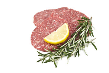 raw hamburgers with transparent protective film