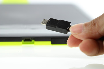 Fingers holding usb cable