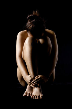 Nude of disappointed girl, sad woman sit, cry, head on knee