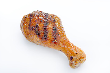 Grilled chicken leg on white background.