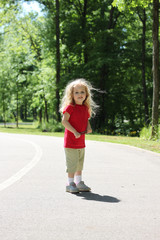 Pretty little girl having fun on the greenway