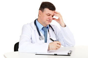 Medical doctor working at desk isolated on white