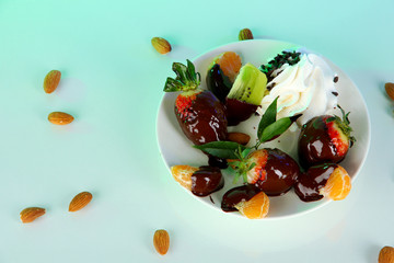 Fruit in chocolate on a light background
