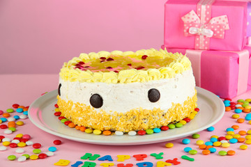 Happy birthday cake and gifts, on pink background