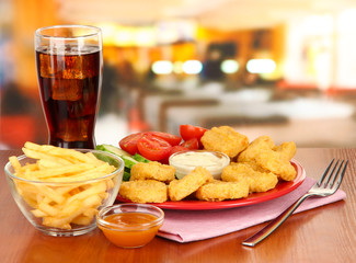 Fried chicken nuggets with vegetables,cola,french fries and