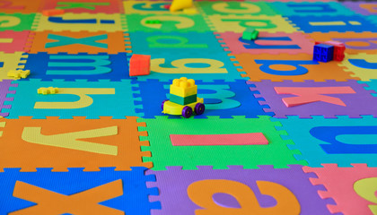 baby toys on puzzlel floor cover, playroom - 50518252