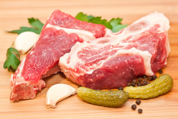 Raw beef with spices and vegetables on the cutting board