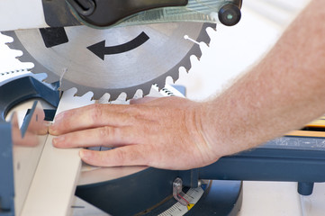 Safety at workplace with circular saw and hand
