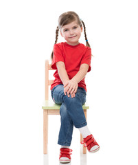 little girl wearing red t-shirt and posing on chair