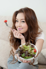 Asian cute girl eating Salad