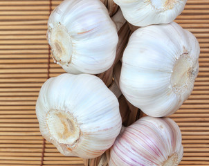 Vegetable spices garlic in the bunch. On a bamboo napkin.