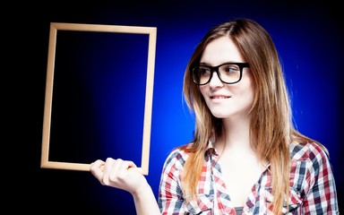 Smiling woman with nerd glasses holding frame