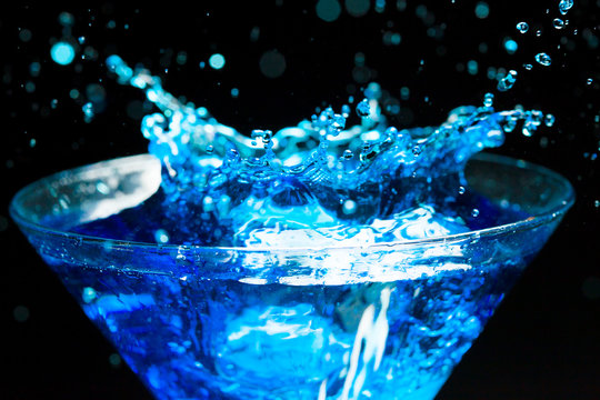 blue splashing cocktail on black