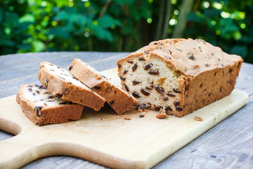 Fresh baked sliced raisin bread on wooden table