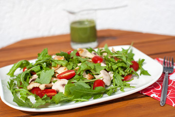 Fresh green salad with rucola tomatoes and grilled chicken