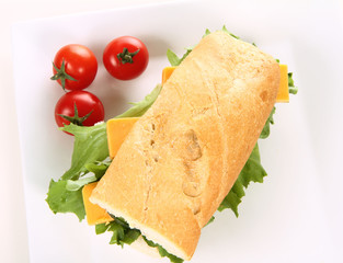 Sandwich with cheese, cucumber, tomato and lettuce