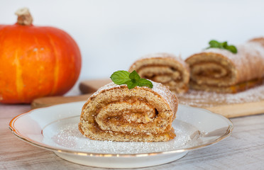 Obraz na płótnie Canvas Swiss roll biscuit with pumpkin and apricot filing
