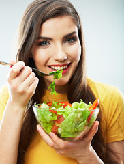 Woman eating salad .