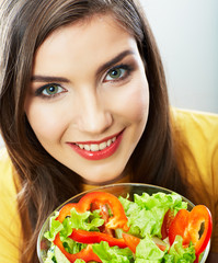 Woman eating salad .