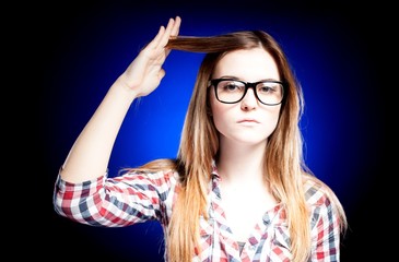 Girl with nerd glasses holding her hair