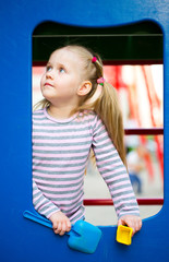 Fototapeta na wymiar Outdoor portrait of playing little girl