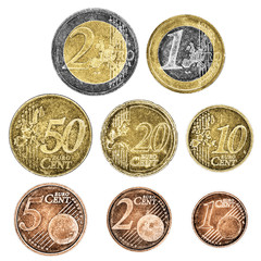 A set of well worn Euro coins on a white background