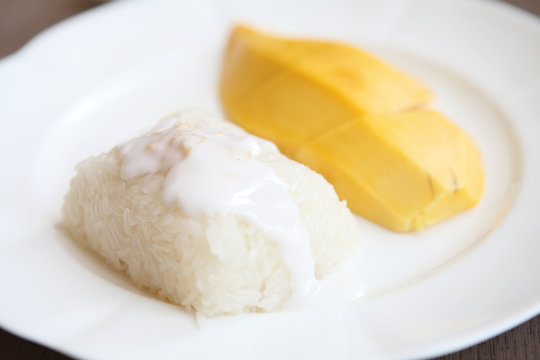 Sticky Rice with Mango on wood background