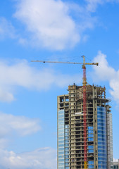 Fototapeta premium Modern building under construction against blue sky