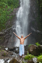 Handsome man at waterfall