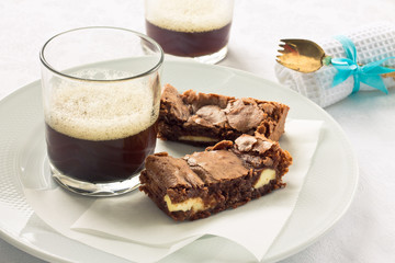 Cream cheese brownies on a white plate