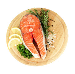 Fresh salmon steak on cutting board, isolated on white