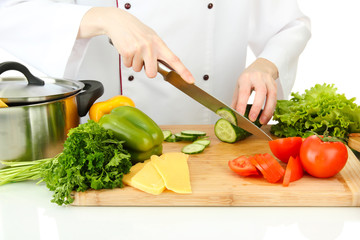 Female hands cutting vegetables, isolated on white