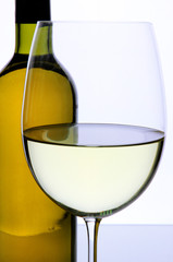 White wine glass and bottle of wine isolated on white