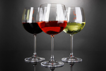 Assortment of wine in glasses on grey background