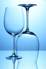 Empty wine glasses arranged on blue background