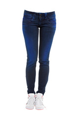 Young woman legs with dyed blue jeans and sneakers