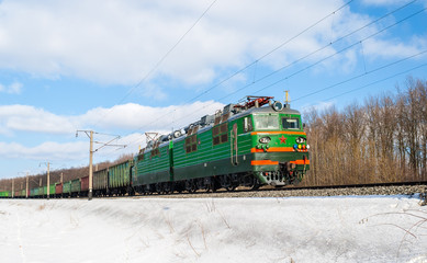 Obraz premium Freight train hauled by electric locomotive. Ukrainian railways