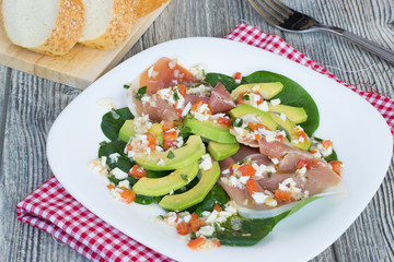 Salad with avocado, jamon and spinach