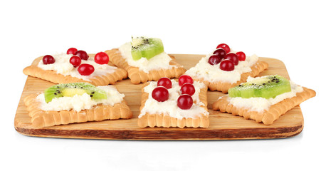 Tasty canapes with cheese, kiwi and cranberry,