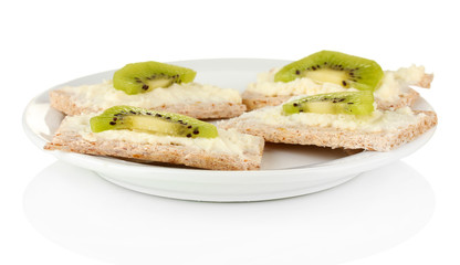 Canapes with cheese and kiwi, on color plate, isolated on white