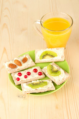 Tasty canapes with cheese, kiwi and cranberry, almond,