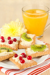 Tasty canapes with cheese and kiwi, cranberry,
