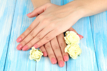 Woman hands with pink manicure and flowers,